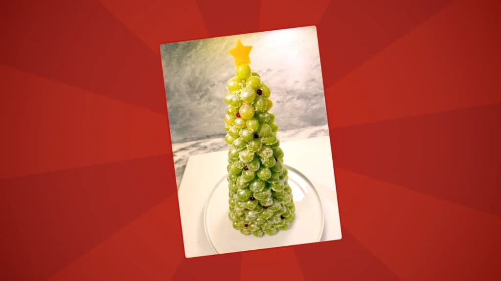 The finalised frozen prosecco grape tree with a cheese star on top on a red backgound