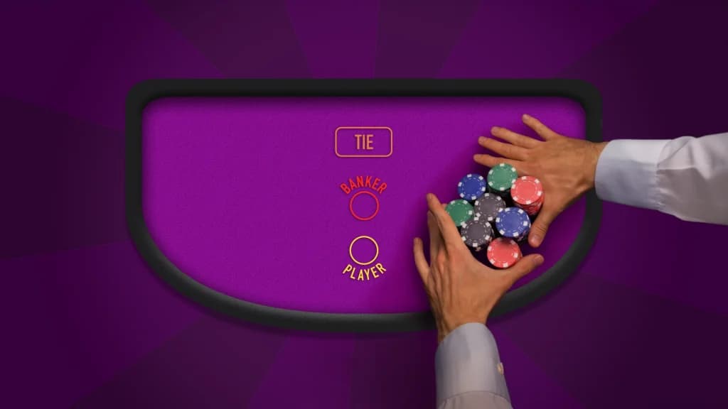 Overhead view of a baccarat table with Tie, Banker, and Player betting circles and a stack of casino chips being placed by a player.
