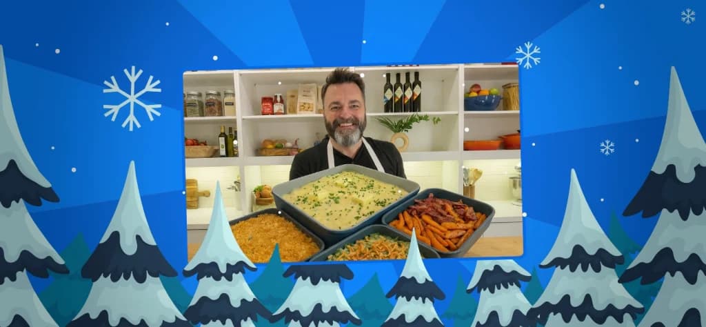 chef eric james holds all his holiday dishes on a blue background with snowy pine trees