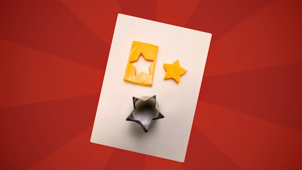 a star shaped cookie cutter with a slice of cheese and a star shaped piece of cheese