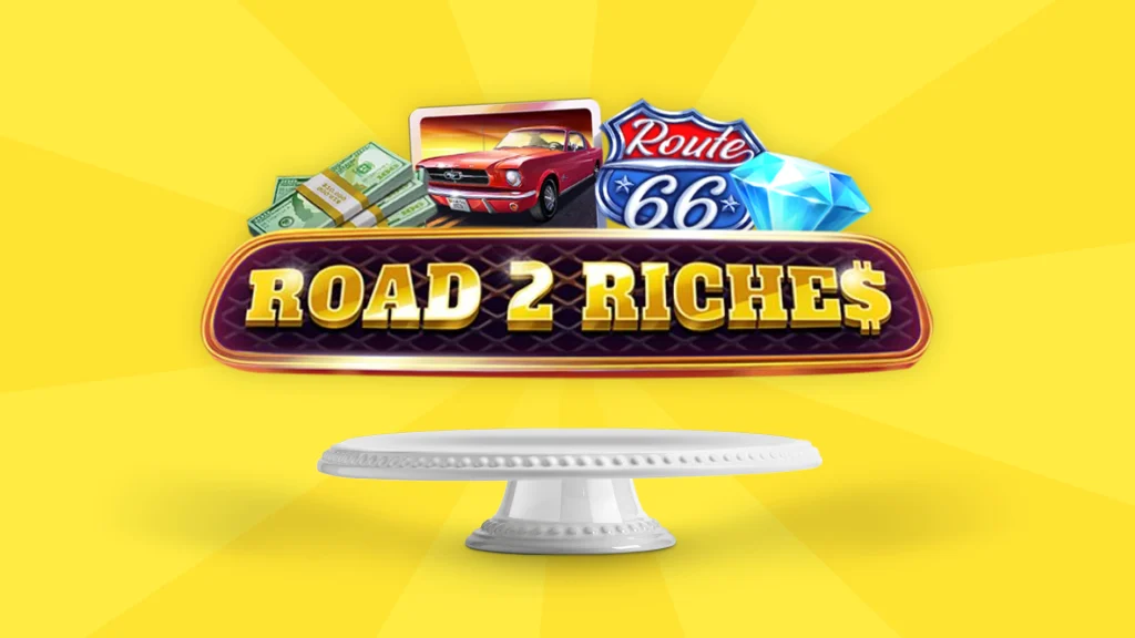 There’s a bright yellow background and an open cake plate in the middle with text that says ‘Road 2 Riches’ and a convertible, Route 66 sign, cash, and diamonds are above it.