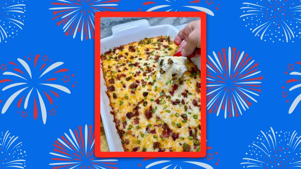 A person dipping chips into a casserole dish of Jalapeno popper dip.