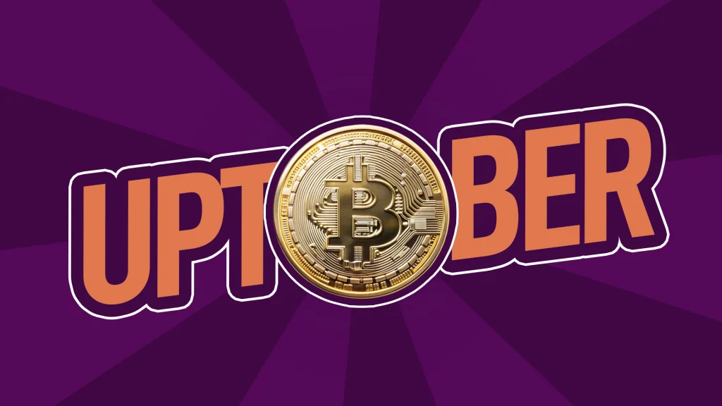 The word uptober shows on a purple background with a bitcoin replacing the O