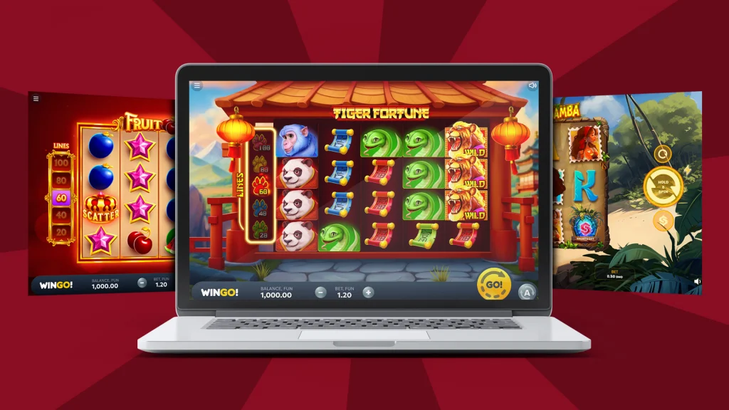 There’s a laptop with the slot game “Tiger Fortune” in the center and two additional slot games mid-play on either side. It’s all displayed on a dark red background. 