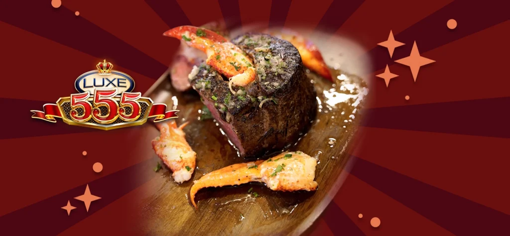 The lobster stuffed filet mignon served on a wooden board with a red background and the luxe 555 slot game logo