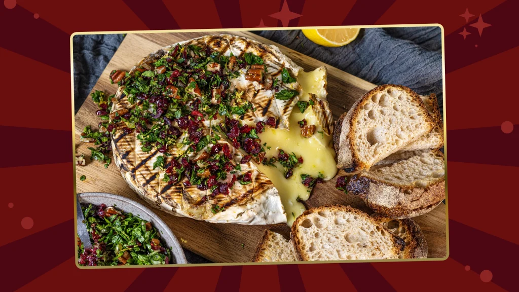 grilled brie sliced on one side and melting with the gremolata topping and baguette bread