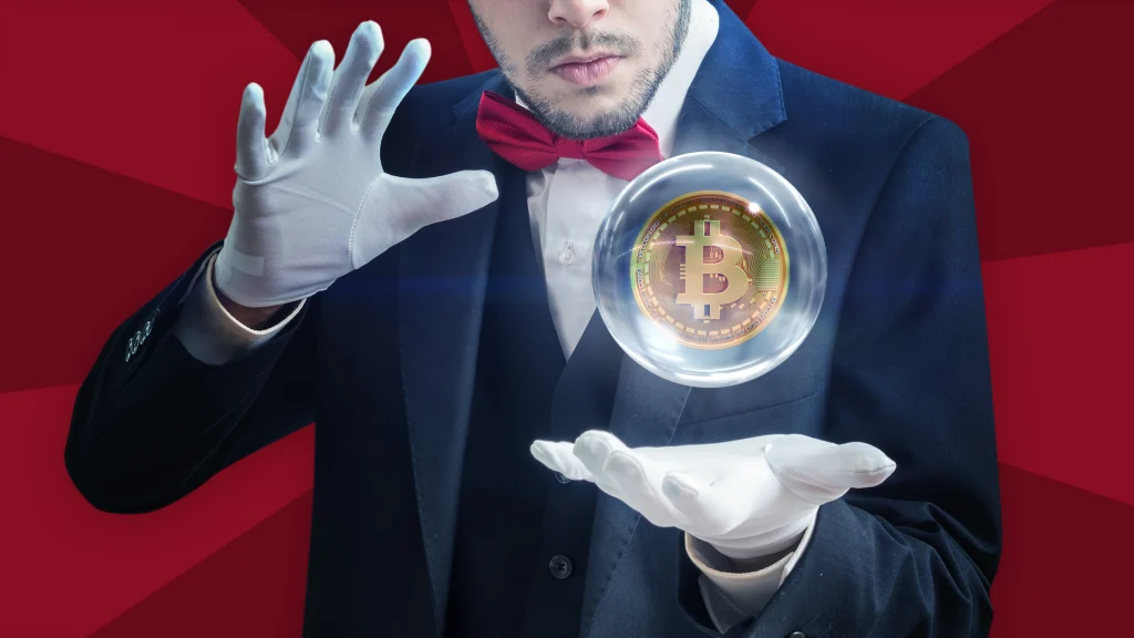 A man in a dark blue suit and white gloves makes a crystal ball with a Bitcoin token inside hover between his hands. Behind him is a dark red background.