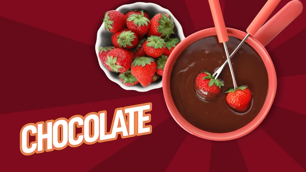 Desert style chocolate sauce and strawberries with two spoons submerged in the chocolate on a red background.