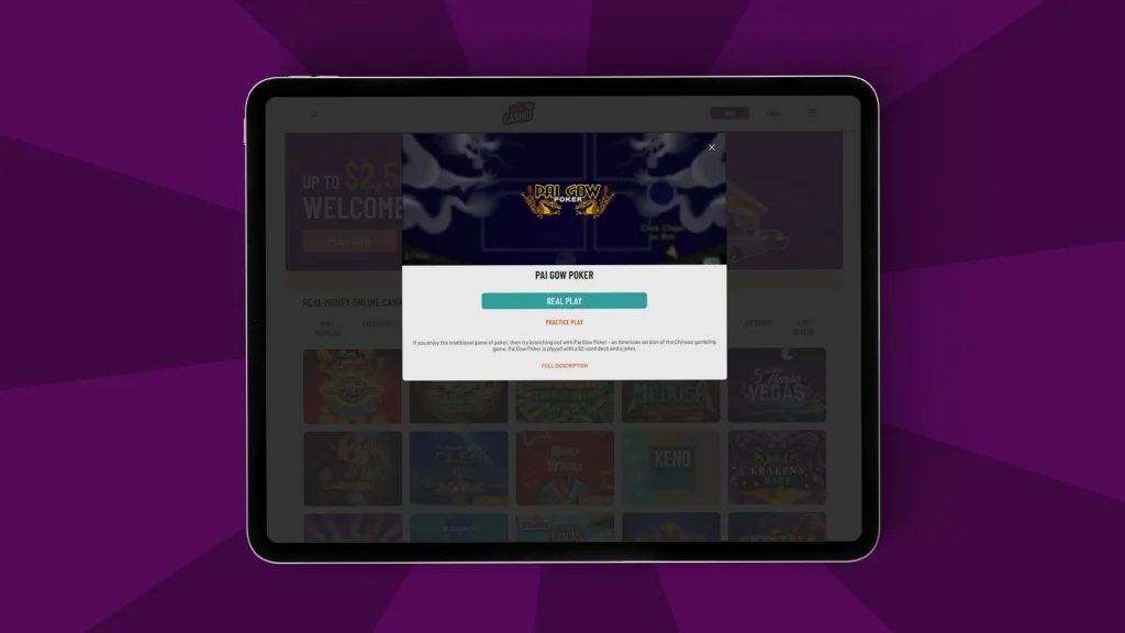 An iPad screen shows the Pai Gow poker game’s opening screen at Cafe Casino, shown on a dark purple background. 