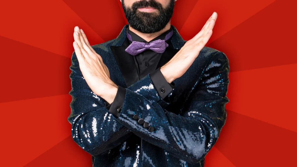 A man with a beard in a black sequined suit is crossing his arms in the center of a red image.