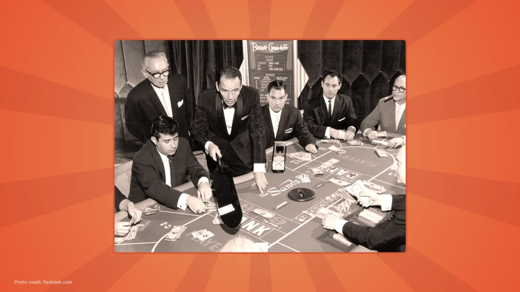 Frank Sinatra at a craps table in a vintage black-and-white photo at the Sands Hotel in Las Vegas.